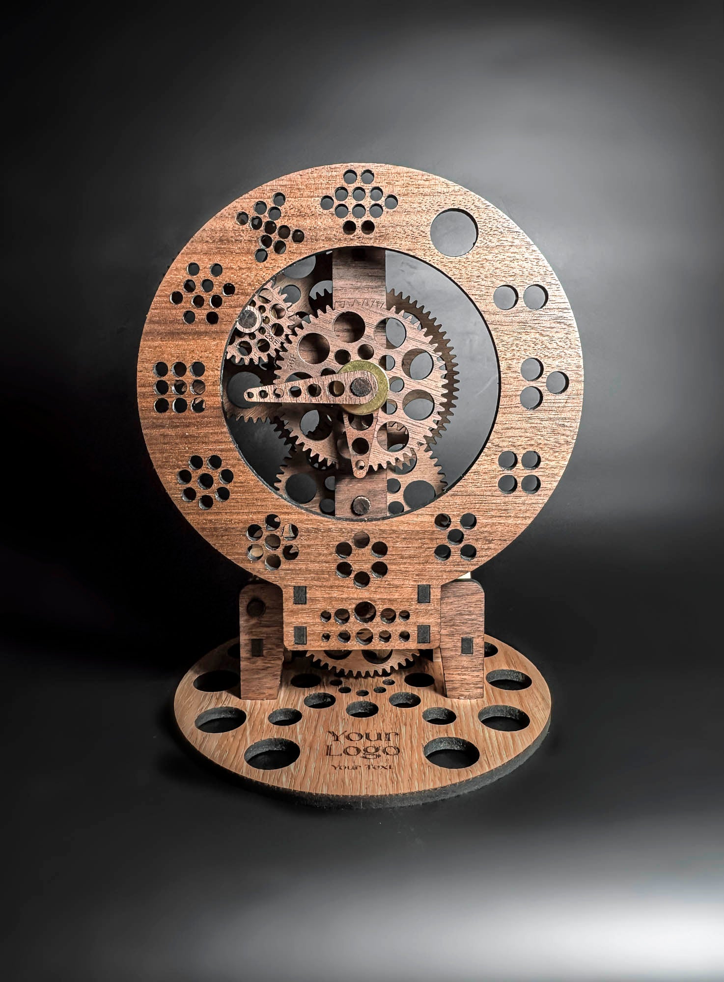 Wooden mechanical sculpture with gears on a dark background
